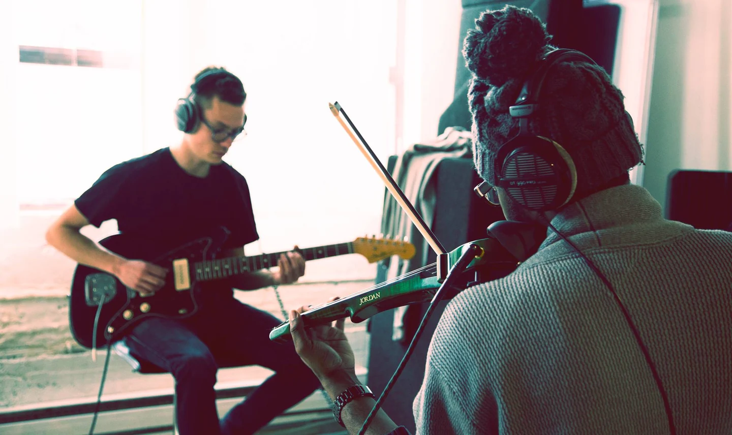 Andrew Forde recording violin in a studio with a guitarist